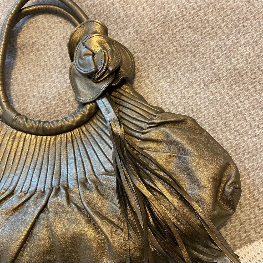 Elegant Gold Handbag with Floral Accent